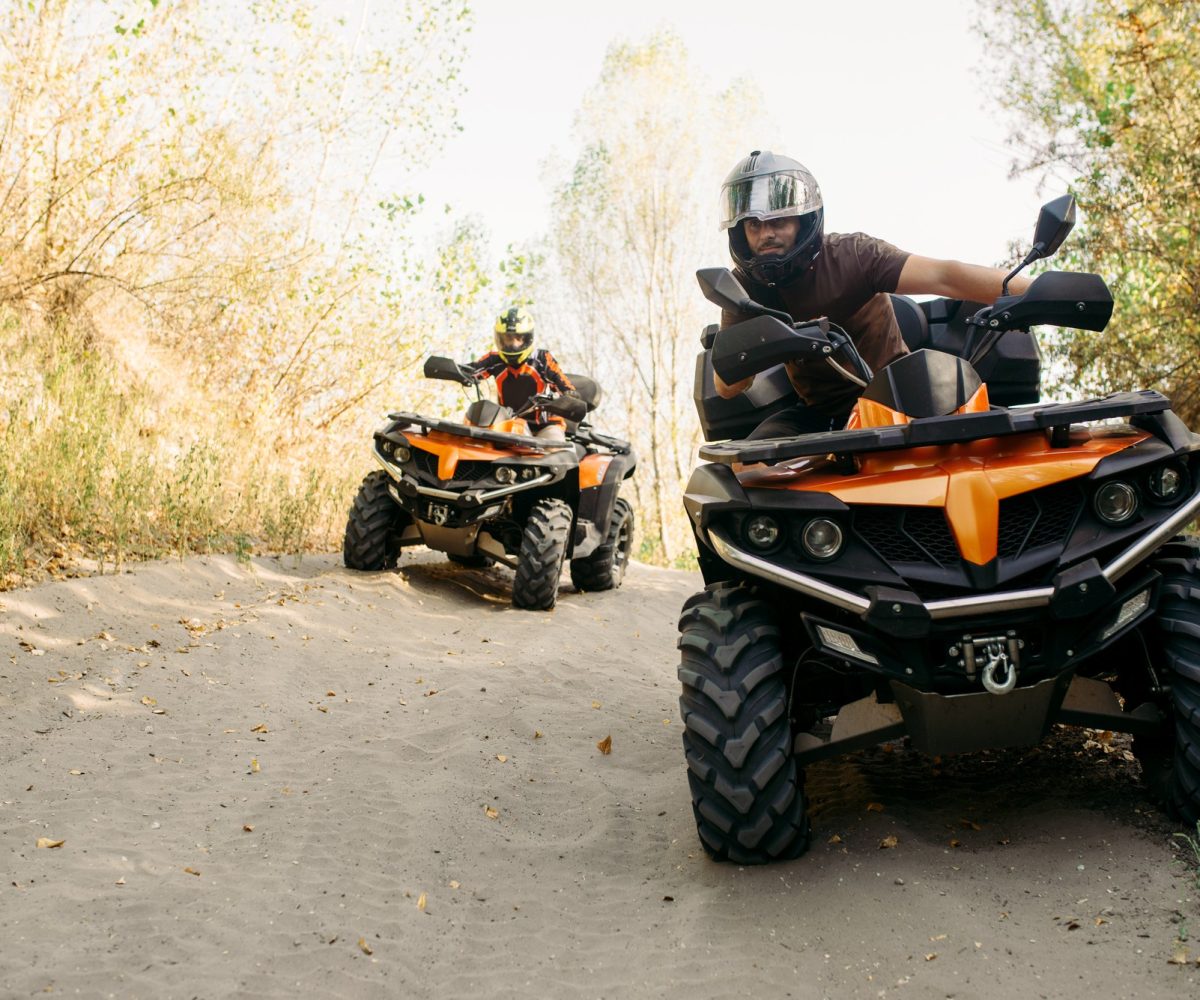 two-quad-bike-riders-helmets-travels-forest-front-view-riding-atv-extreme-sport-travelling-quadbike-adventure
